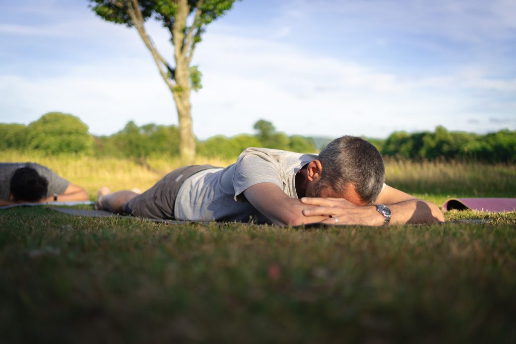A man laying on his front practicing deep relaxation